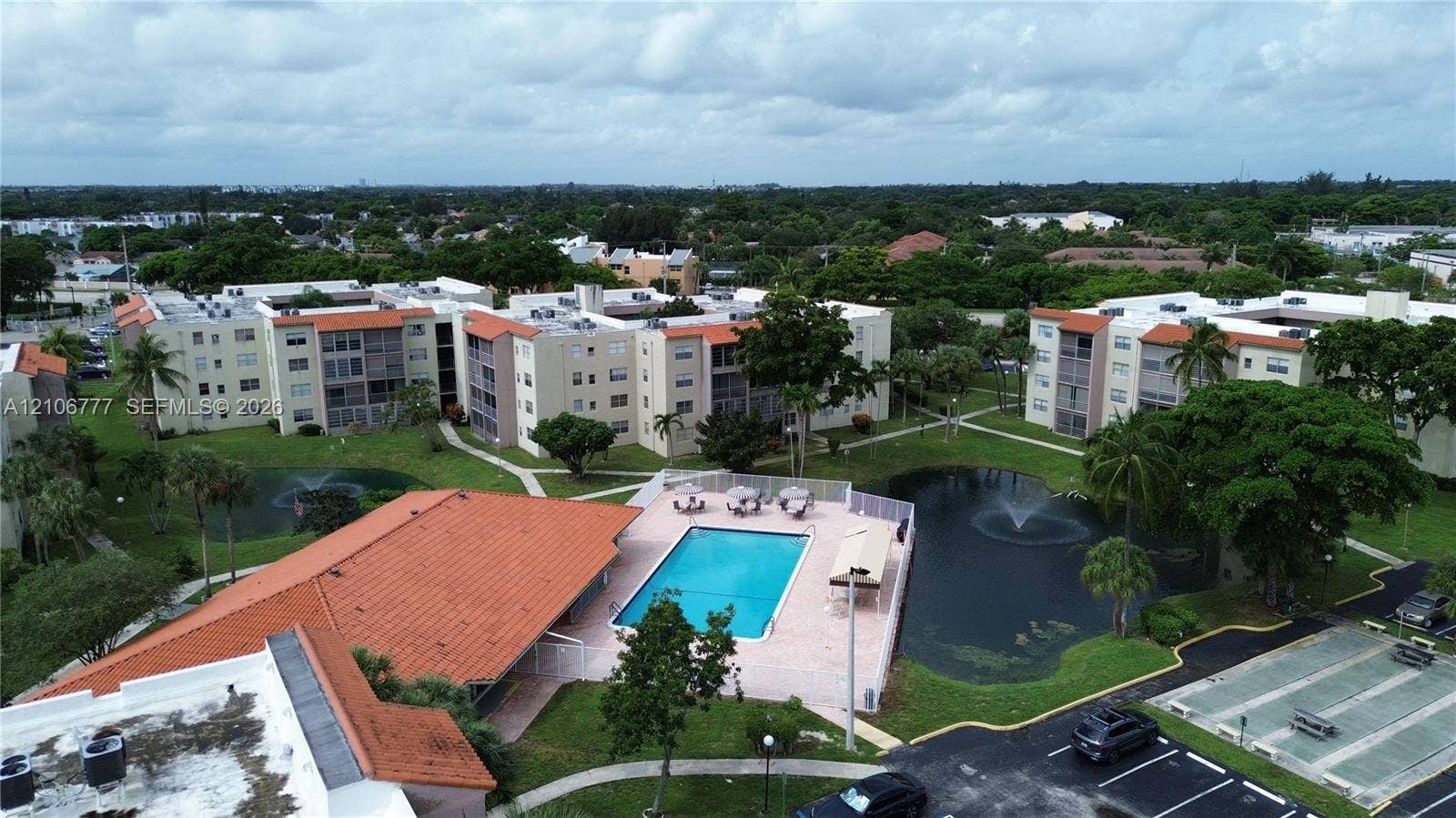 1810 SW 81st Avenue, #2200, North Lauderdale, North Lauderdale, FL 33068 Community amenities include a swimming pool, two fountain-equipped ponds, landscaped grounds with mature trees, and an outdoor shuffleboard court