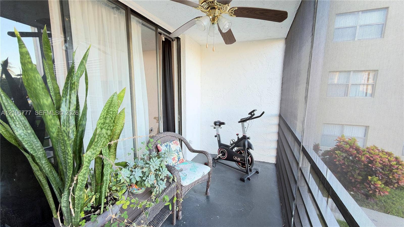 1810 SW 81st Avenue, #2200, North Lauderdale, North Lauderdale, FL 33068 Screened-in balcony featuring a ceiling fan with integrated lighting and sliding glass door access