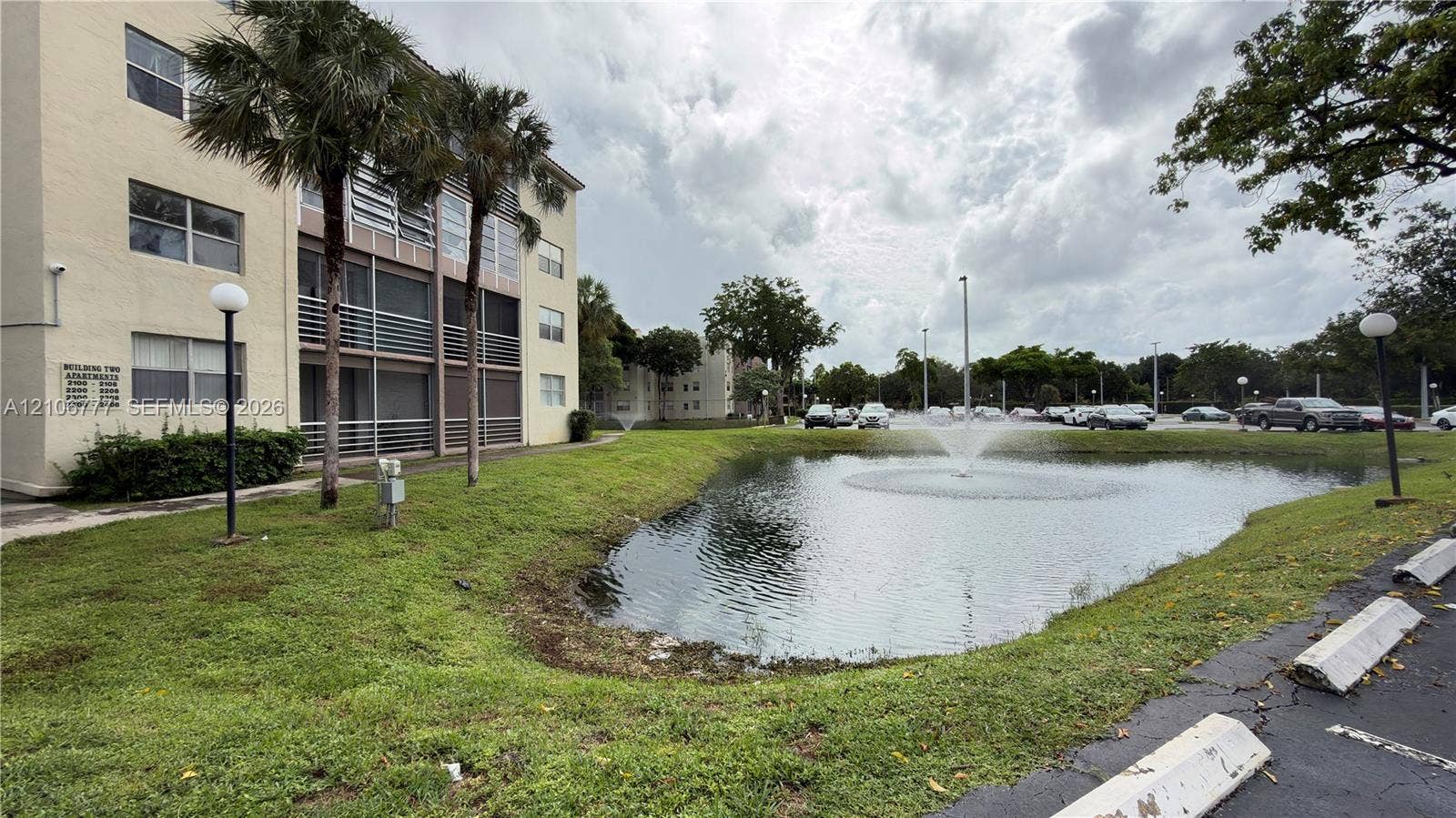 1810 SW 81st Avenue, #2200, North Lauderdale, North Lauderdale, FL 33068 Multi-story stucco exterior featuring screened balconies, landscaped grounds, and a central water fountain pond