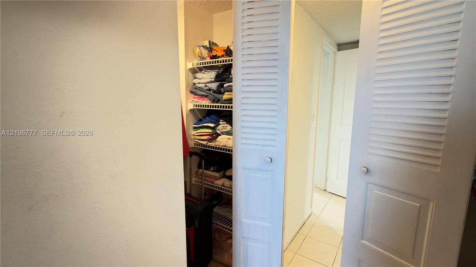1810 SW 81st Avenue, #2200, North Lauderdale, North Lauderdale, FL 33068 Storage closet featuring white louvered bifold doors and integrated wire shelving