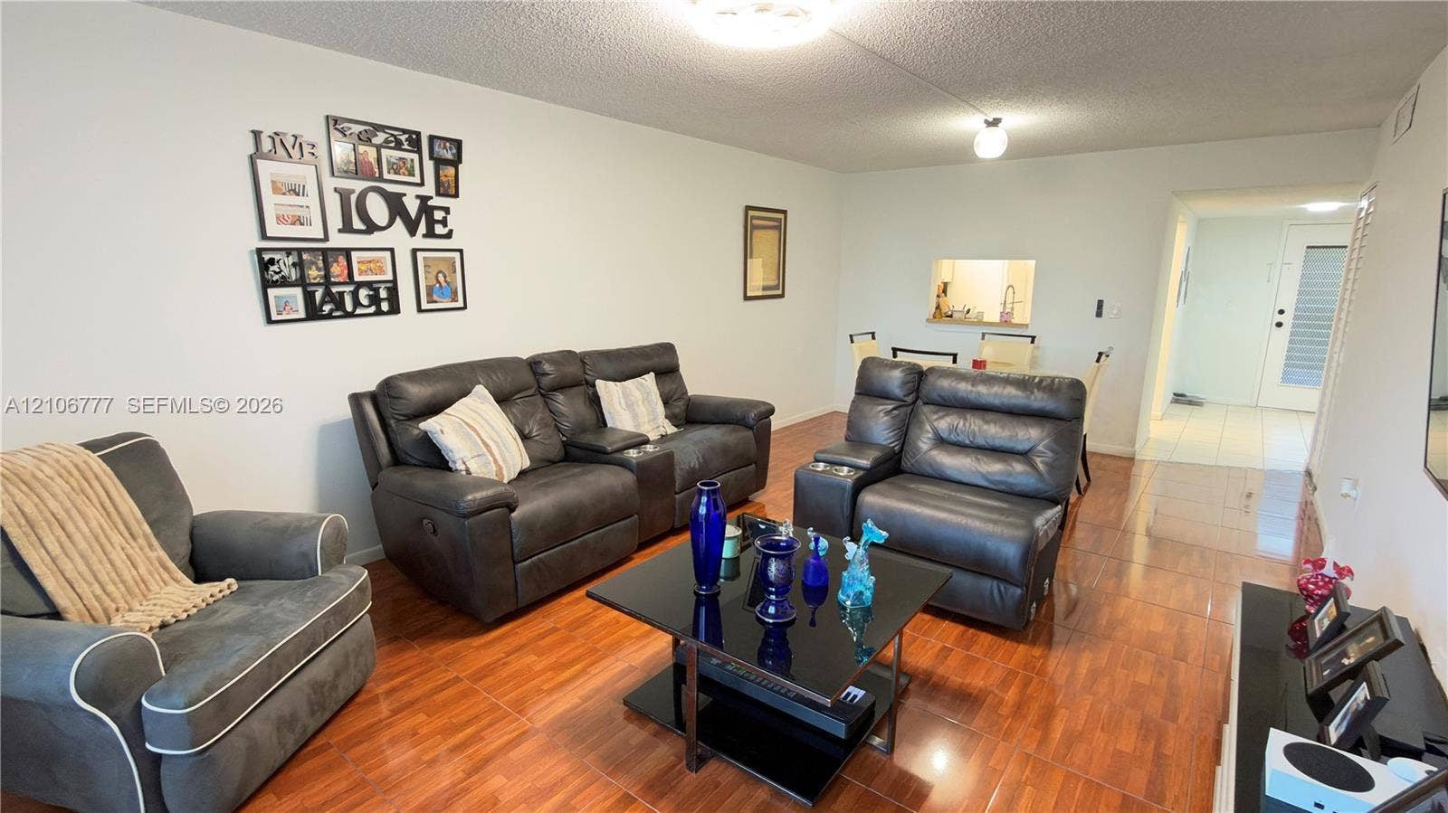 1810 SW 81st Avenue, #2200, North Lauderdale, North Lauderdale, FL 33068 Open-concept interior featuring wood-finish tile flooring, ceiling-mounted light fixtures, and a pass-through kitchen opening
