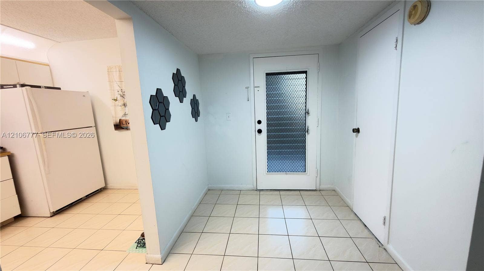 1810 SW 81st Avenue, #2200, North Lauderdale, North Lauderdale, FL 33068 Entryway featuring white tile flooring, flush-mount ceiling lighting, and a glass-paneled exterior door