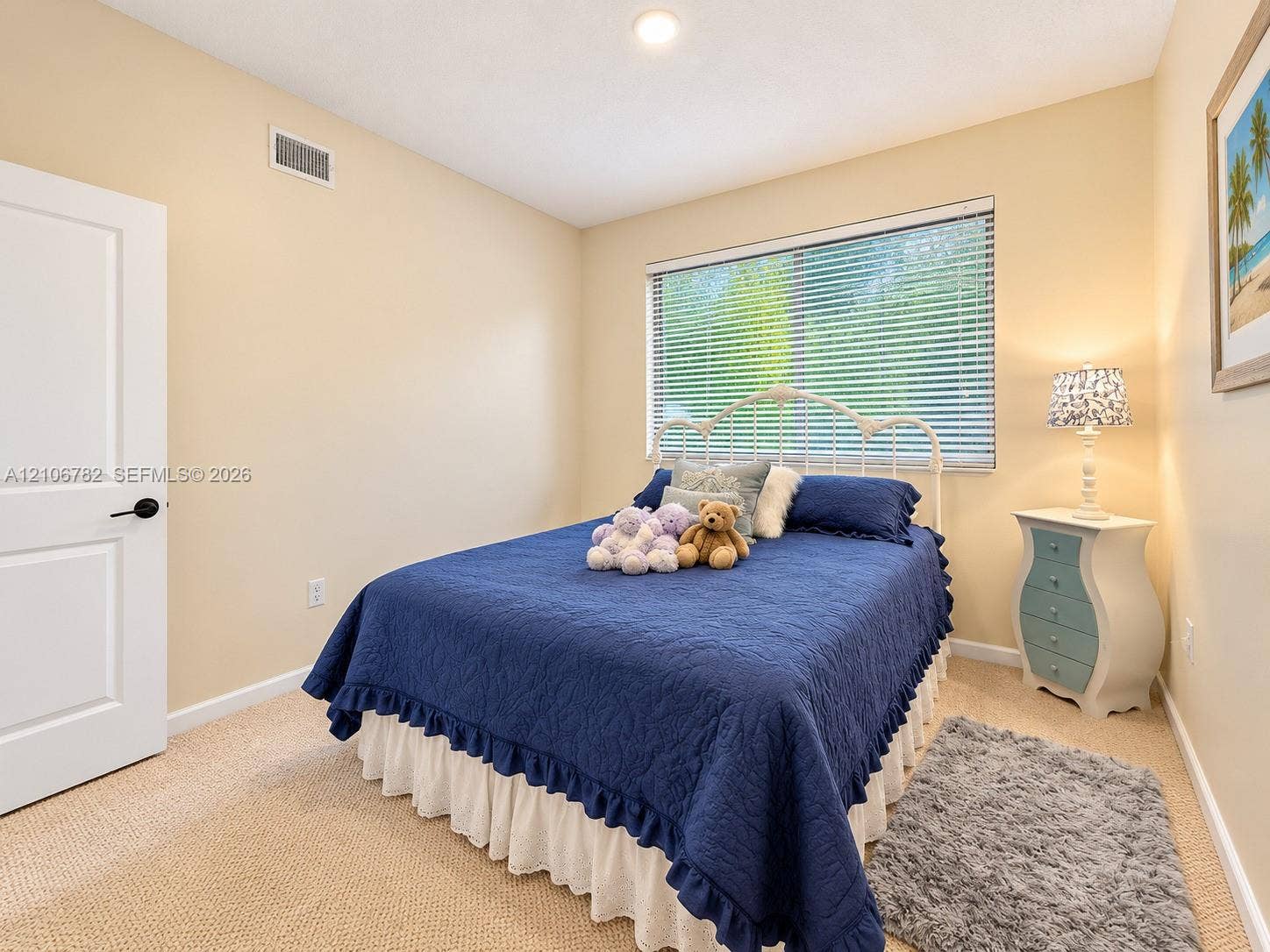 Neutral wall tones, carpeted flooring, recessed ceiling lighting, and a large window featuring horizontal blinds