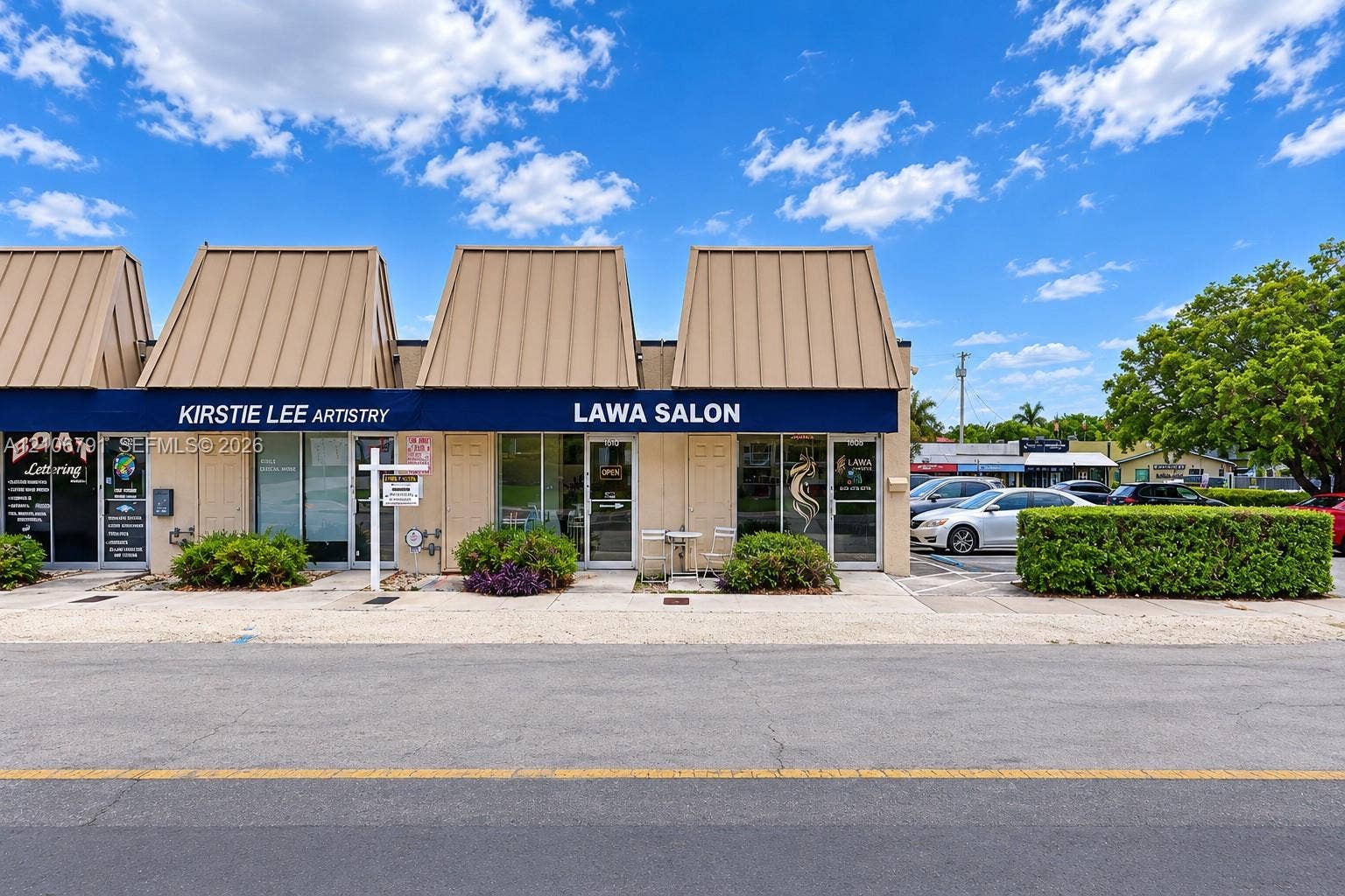 1684 SE 10th Avenue, Fort Lauderdale, Fort Lauderdale, FL 33316 Commercial storefront featuring a metal mansard roof, expansive glass entry doors, and dedicated parking spaces