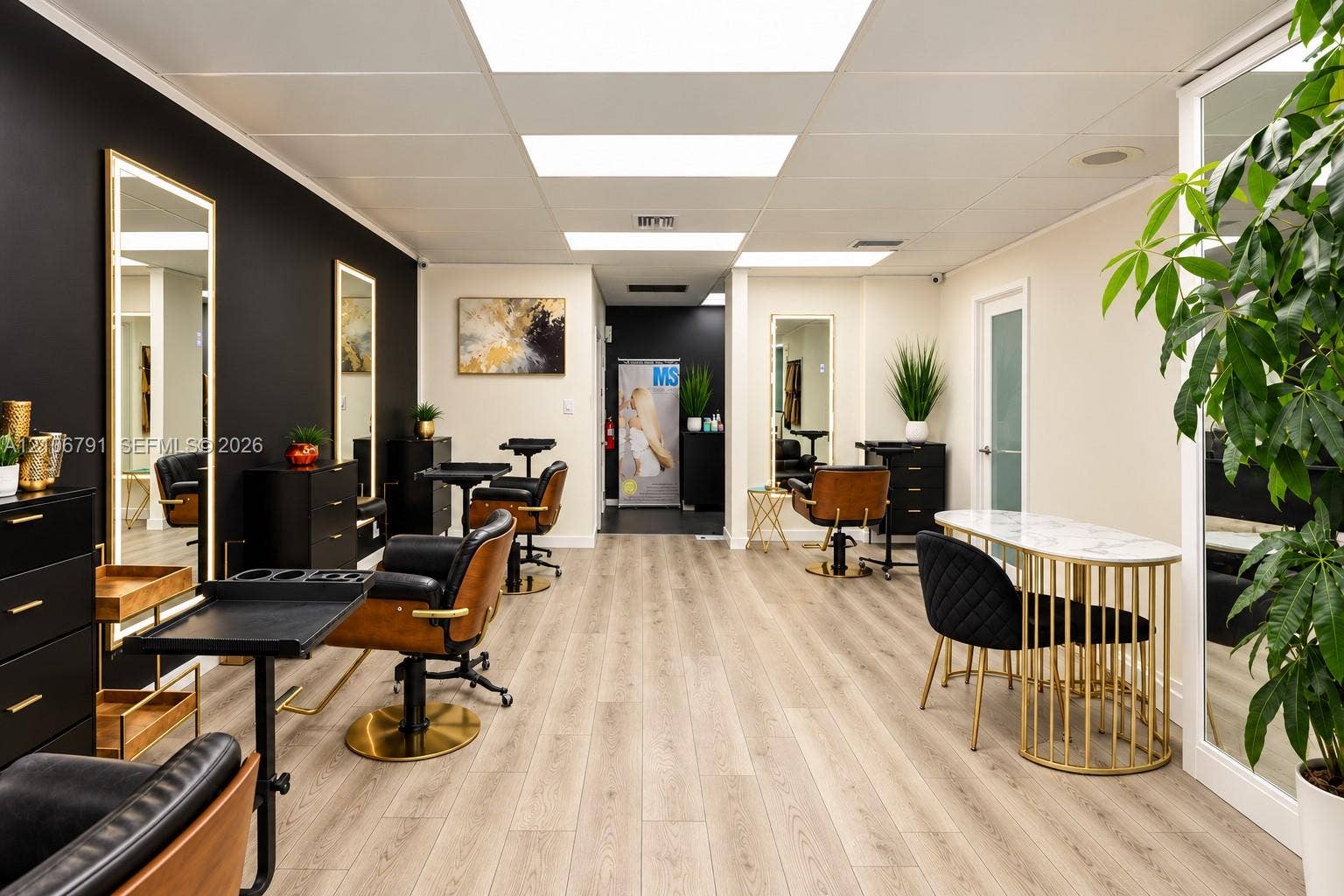 1684 SE 10th Avenue, Fort Lauderdale, Fort Lauderdale, FL 33316 Open-concept interior featuring light wood-finish flooring, high-contrast matte black accent wall, integrated LED-lit vertical mirrors, and recessed ceiling lighting
