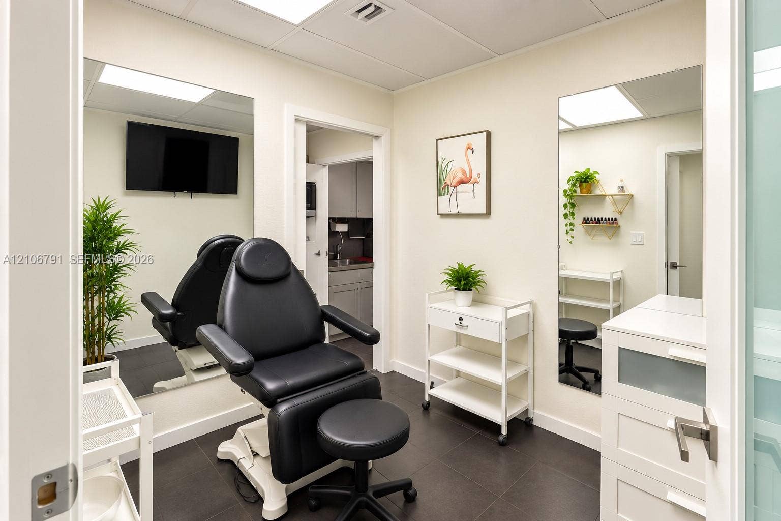 1684 SE 10th Avenue, Fort Lauderdale, Fort Lauderdale, FL 33316 Room featuring dark tile flooring, two full-length wall-mounted mirrors, recessed ceiling lighting, and a built-in cabinet with a sink