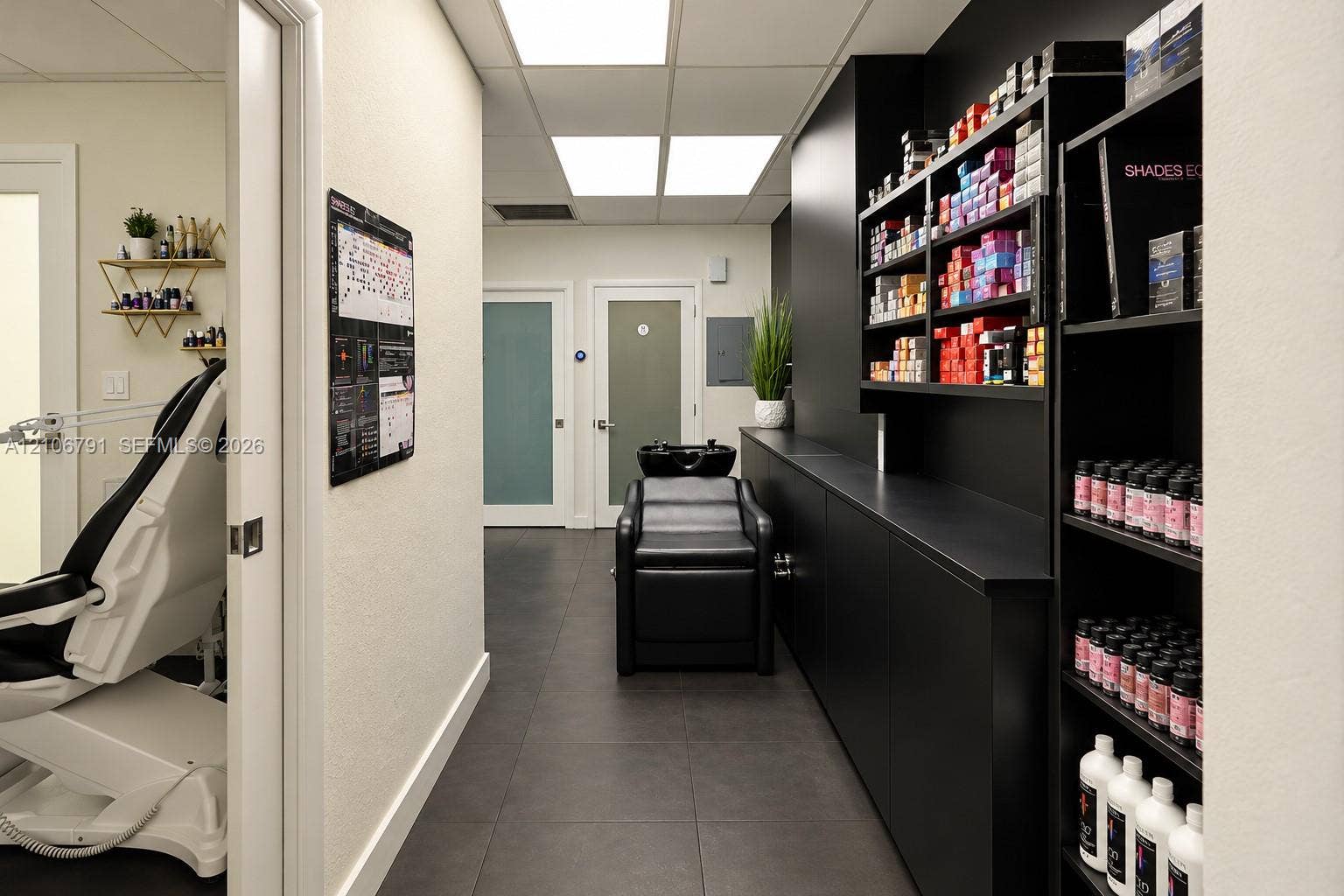 1684 SE 10th Avenue, Fort Lauderdale, Fort Lauderdale, FL 33316 Custom matte black built-in cabinetry, large-format tile flooring, integrated shampoo station, recessed panel ceiling lighting, and dual frosted-glass interior doors