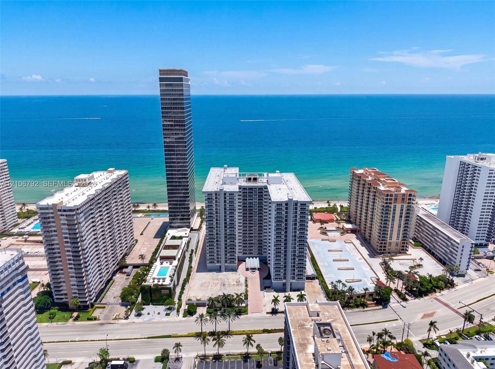 2030 S Ocean Drive, #723, Hallandale Beach, FL 33009 Aerial perspective of oceanfront high-rise residential properties featuring immediate proximity to the coastline, landscaped grounds, and paved parking areas