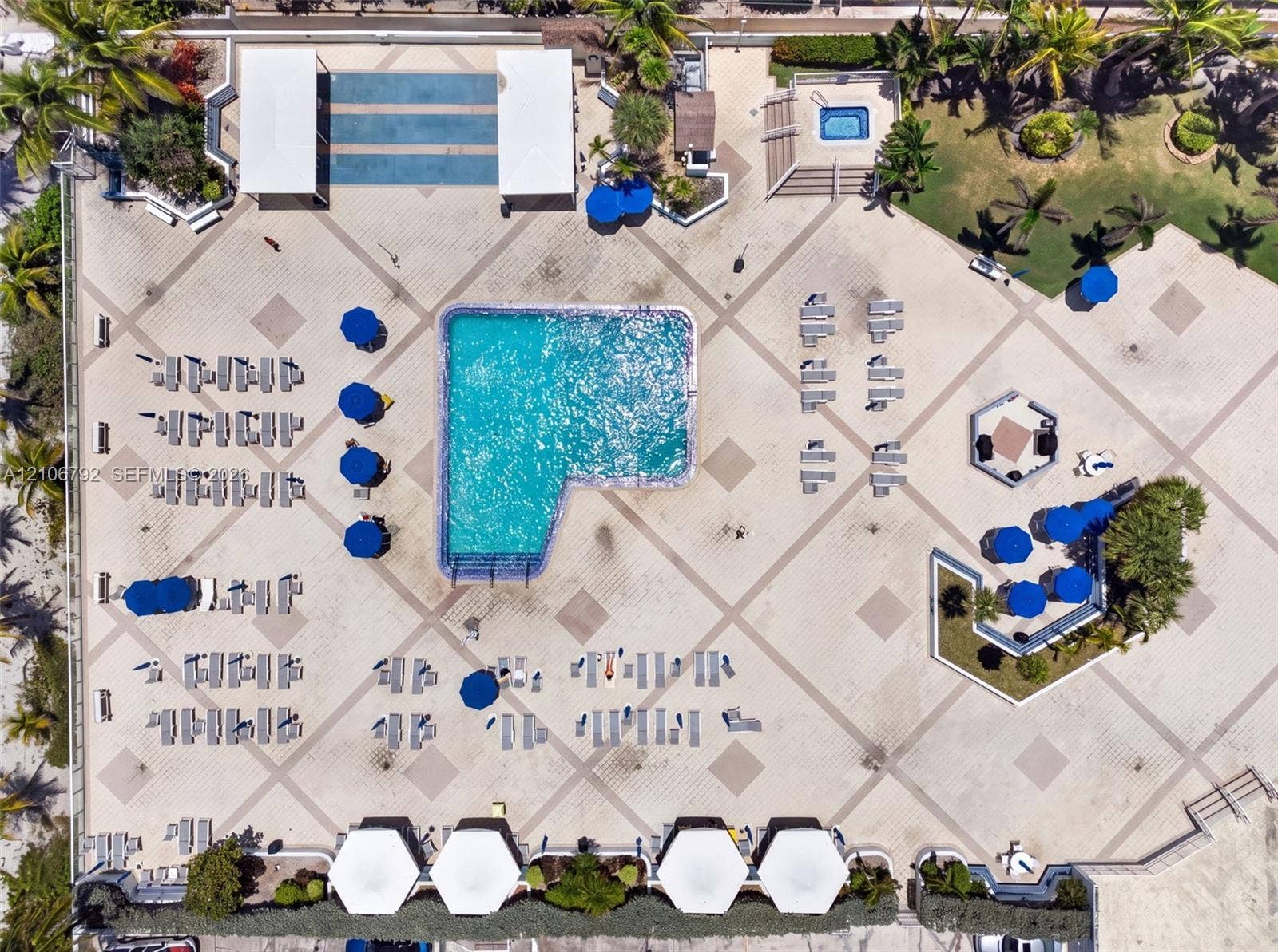 2030 S Ocean Drive, #723, Hallandale Beach, FL 33009 Aerial perspective of a pool area featuring a multi-level swimming pool, an elevated spa, expansive stone-paver decking, and dedicated shaded structures