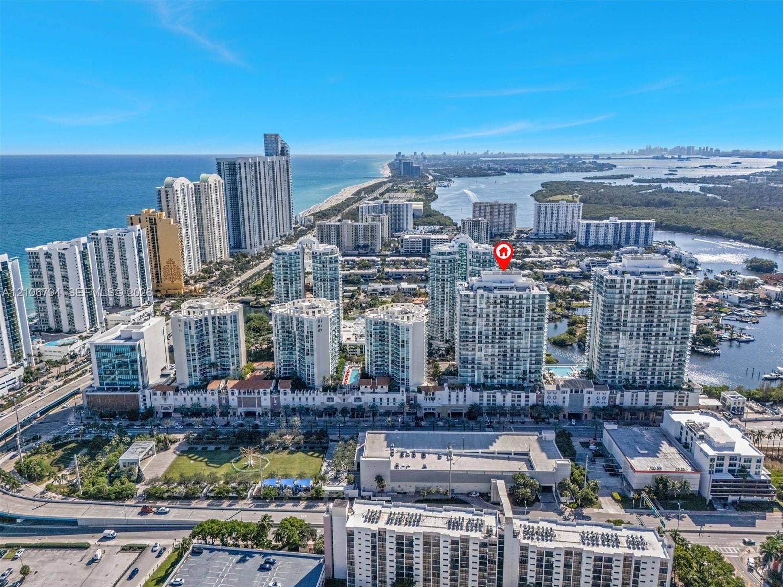 High-rise condominium building featuring glass exterior cladding, a location within a coastal metropolitan area, and proximity to Atlantic oceanfront and inland waterways