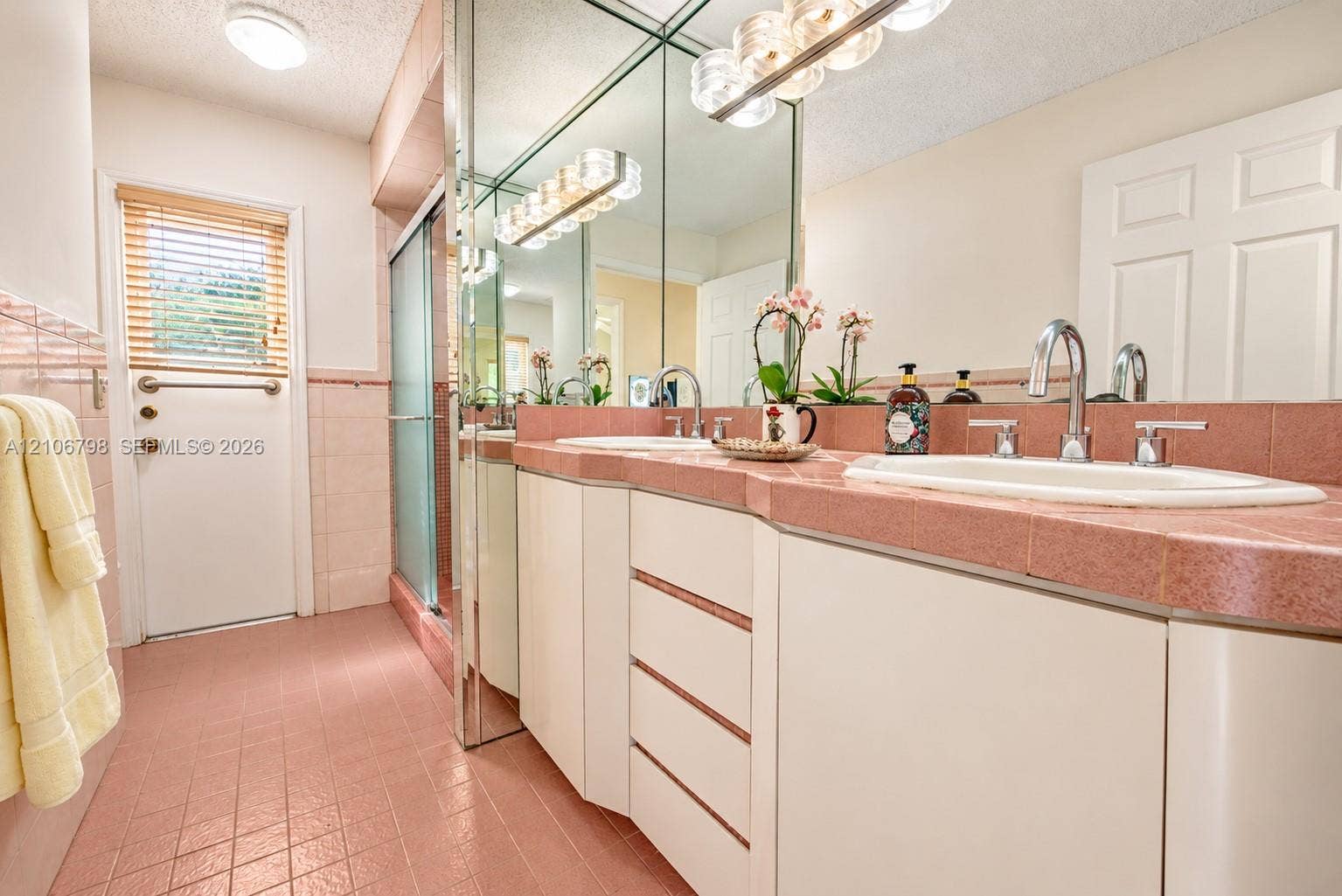 14750 SW 156th Street, Miami, FL 33187 Double vanity featuring white cabinetry, tile countertops, integrated sinks, dual chrome faucets, and floor-to-ceiling mirror panels