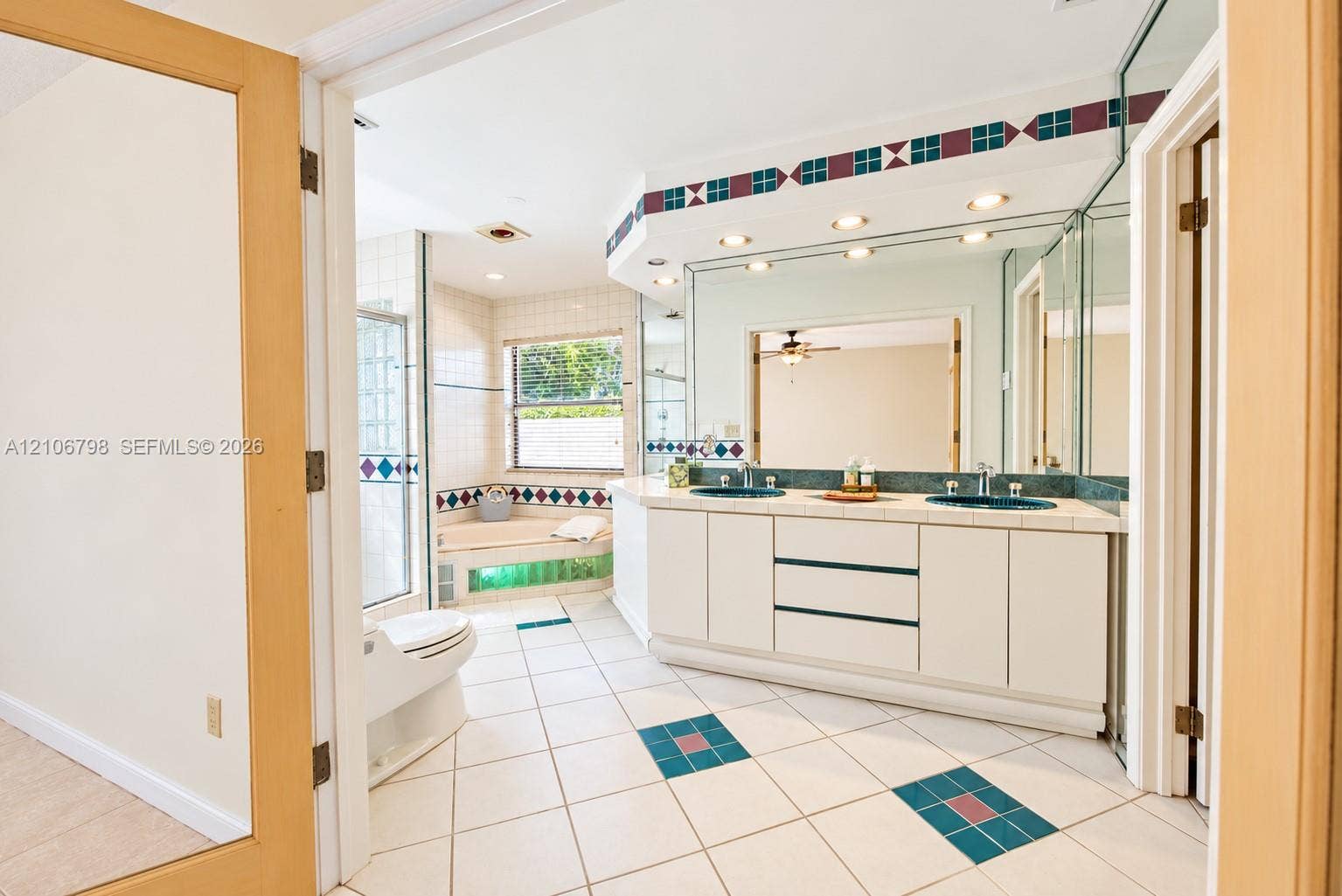 14750 SW 156th Street, Miami, FL 33187 Bathroom featuring a dual-sink vanity with tile countertops, a soaking tub, recessed ceiling lighting, glass-enclosed shower, and decorative tile flooring