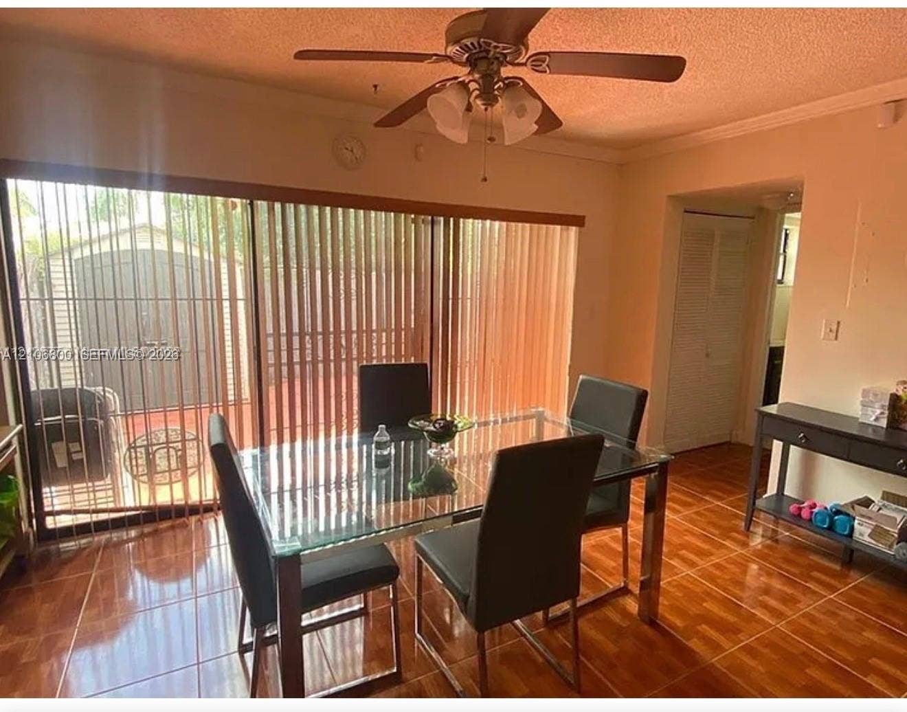 3820 SW 52nd Avenue, Hollywood, Hollywood, FL 33023 Ceramic tile flooring, multi-panel sliding glass door with vertical blinds, and a ceiling-mounted light fixture with fan