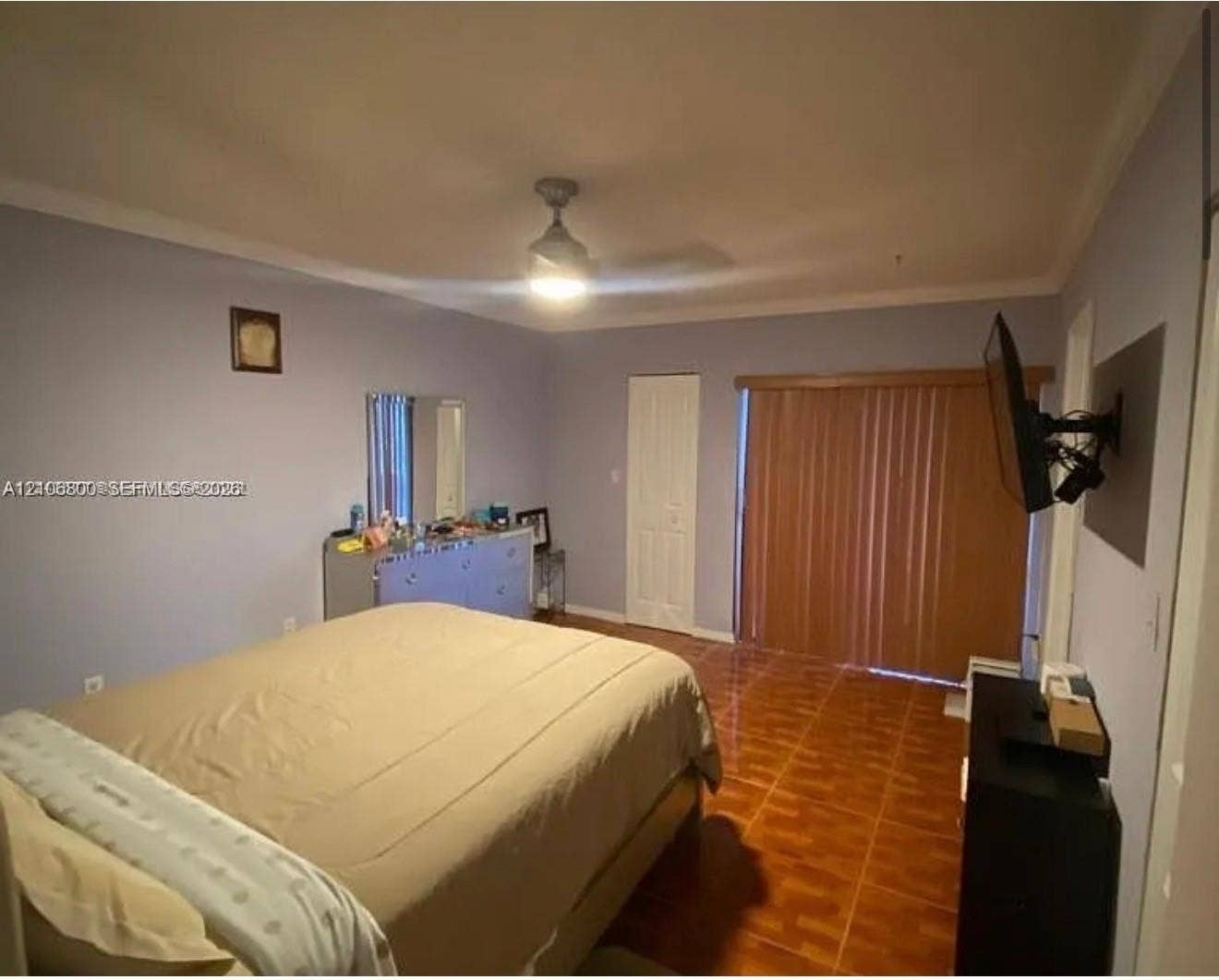3820 SW 52nd Avenue, Hollywood, Hollywood, FL 33023 Ceramic tile flooring, crown molding, ceiling fan with integrated lighting, and vertical sliding glass doors