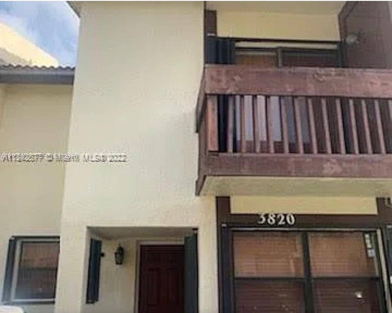 3820 SW 52nd Avenue, Hollywood, Hollywood, FL 33023 Stucco exterior featuring a wood-rail balcony, dark-frame windows, and a recessed entrance