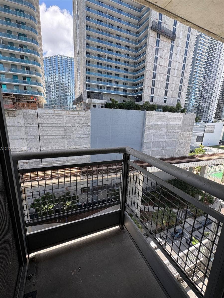 690 SW 1st Court, #1212, Miami, FL 33130 Private balcony featuring concrete flooring and a metal mesh safety railing