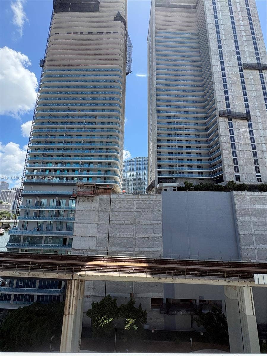 690 SW 1st Court, #1212, Miami, FL 33130 High-rise residential towers featuring glass-paneled balconies and concrete construction