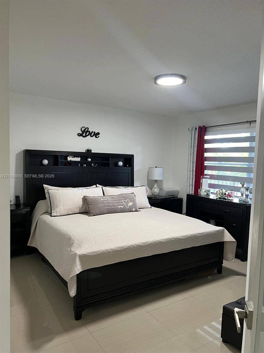 12600 SW 5th Court, #204L, Pembroke Pines, FL 33027 Neutral-toned tile flooring, flush-mount LED ceiling lighting, and dual-layered window blinds
