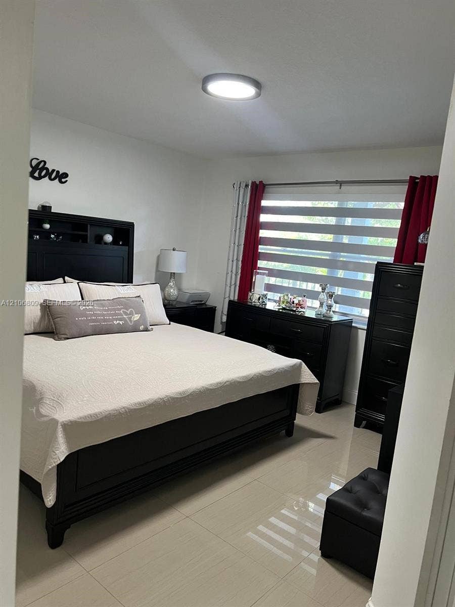 12600 SW 5th Court, #204L, Pembroke Pines, FL 33027 Neutral-toned large-format tile flooring, flush-mount circular overhead lighting, and adjustable horizontal dual-shade window treatments