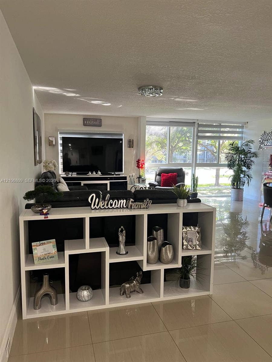 12600 SW 5th Court, #204L, Pembroke Pines, FL 33027 Neutral-toned large-format tile flooring, floor-to-ceiling windows, and recessed ceiling lighting