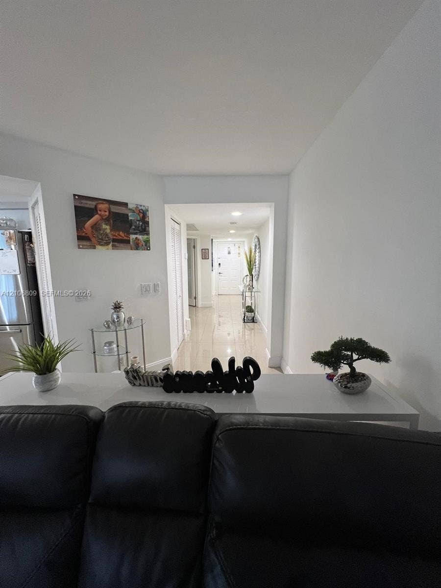 12600 SW 5th Court, #204L, Pembroke Pines, FL 33027 Interior hall featuring high-gloss tile flooring, recessed lighting, and multi-panel bi-fold doors