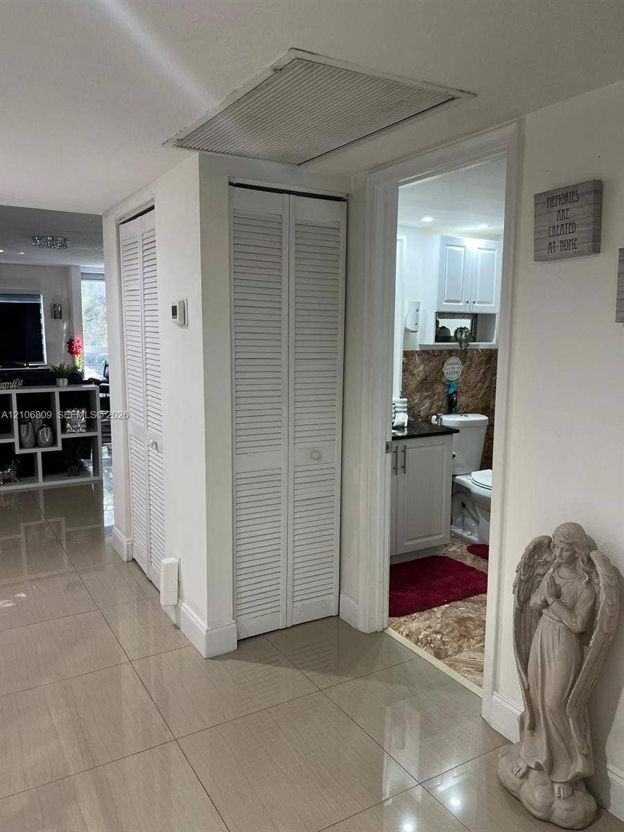 12600 SW 5th Court, #204L, Pembroke Pines, FL 33027 Neutral tile flooring throughout with dual white louvered-door closets and recessed lighting