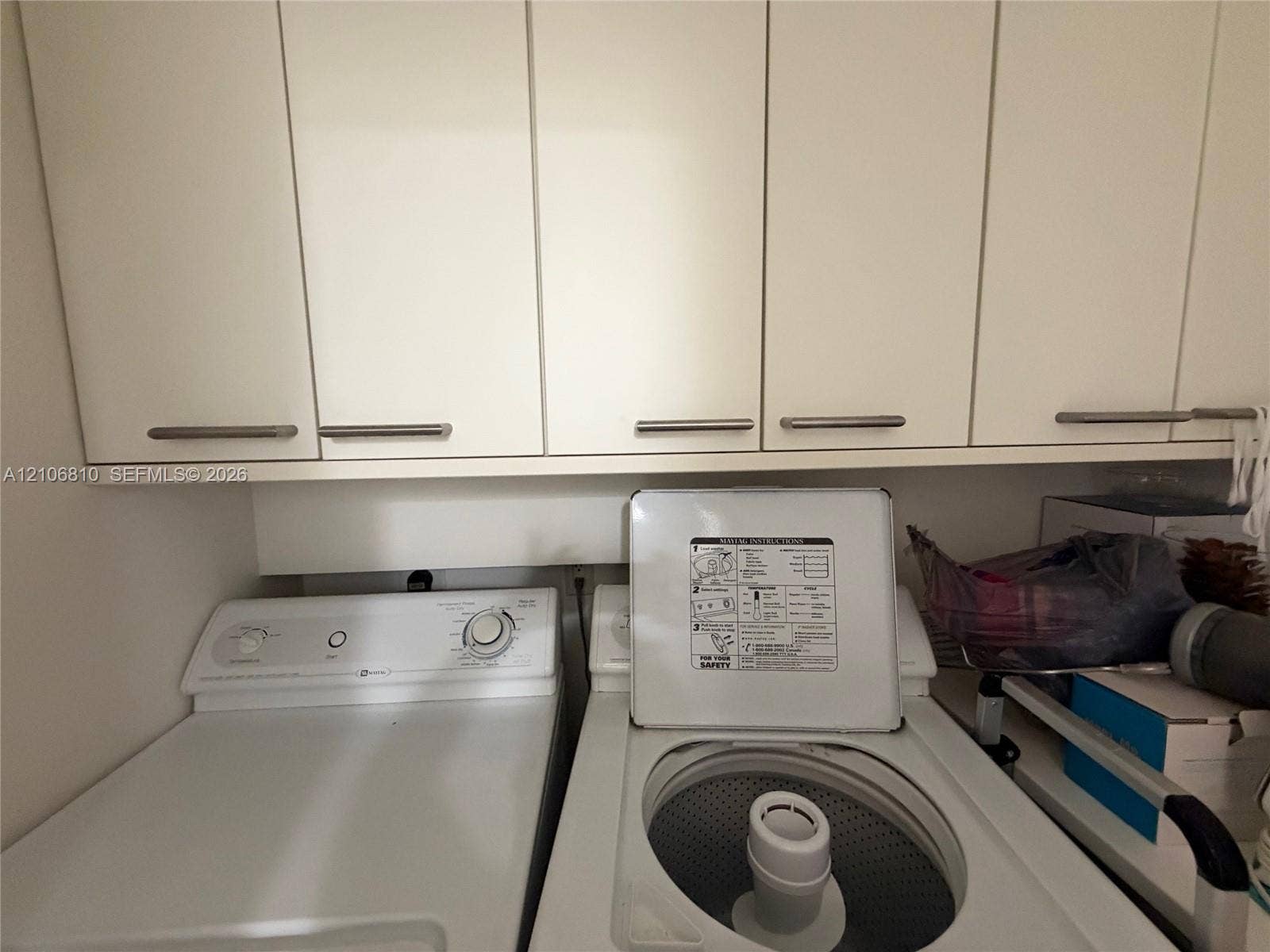 Wall-mounted cabinetry featuring flat-panel doors and brushed metal pulls