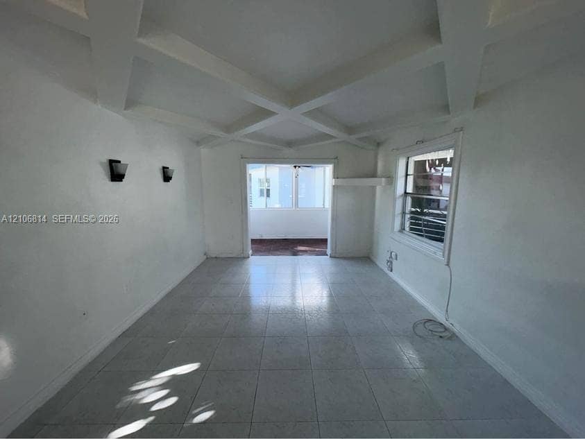 6503 Winfield Boulevard, #211AD, Margate, Margate, FL 33063 Coffered ceiling, tile flooring, wall-mounted light fixtures, and a dual-pane window