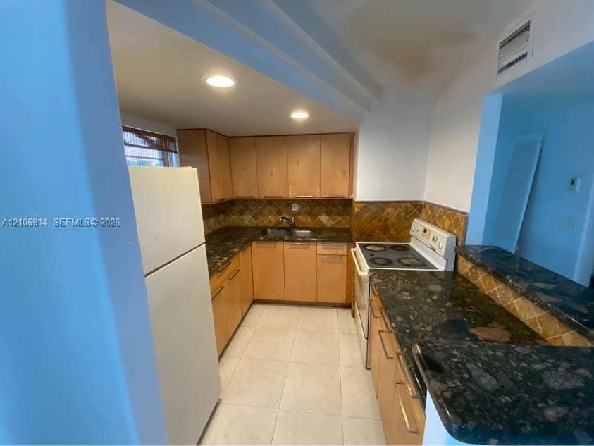 6503 Winfield Boulevard, #211AD, Margate, Margate, FL 33063 Kitchen featuring light-finish cabinetry, stone-surface countertops, tile backsplash, and recessed lighting