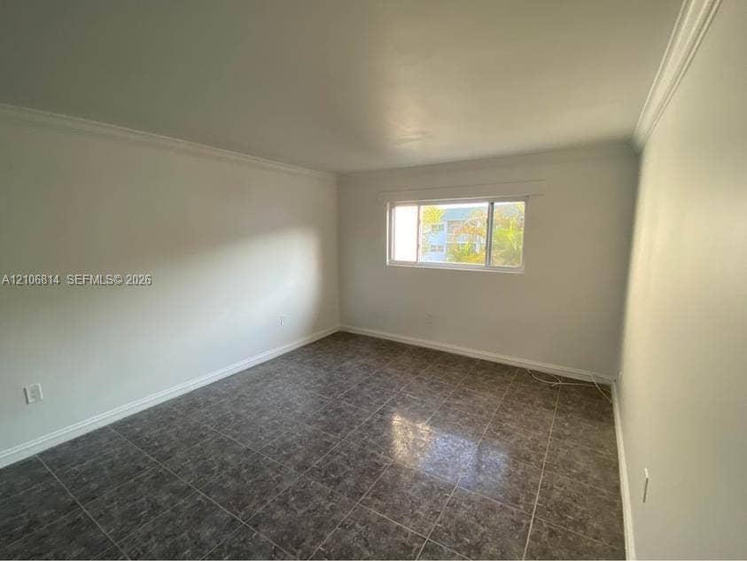 6503 Winfield Boulevard, #211AD, Margate, Margate, FL 33063 Neutral wall finishes, large-format tile flooring, crown molding, and a horizontal sliding window