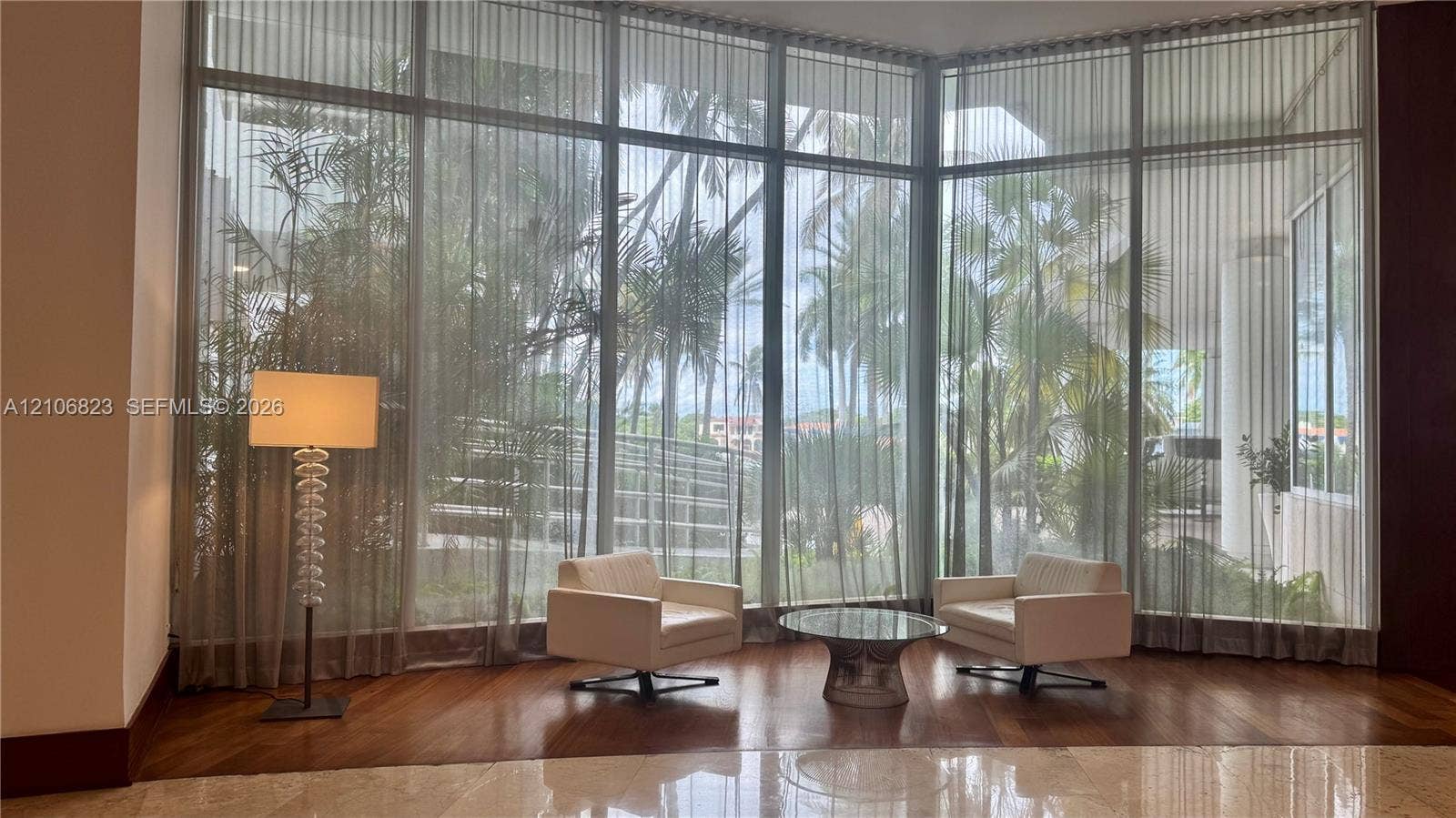 Floor-to-ceiling windows featuring metal framing and wood-finish flooring