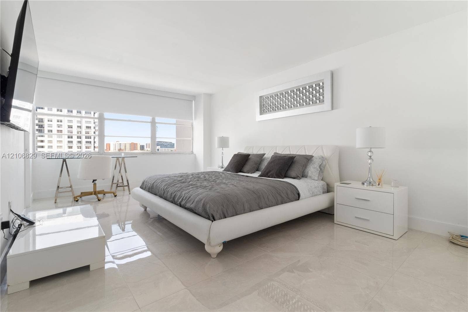Neutral-toned tile flooring, oversized horizontal window with installed shade, and recessed lighting