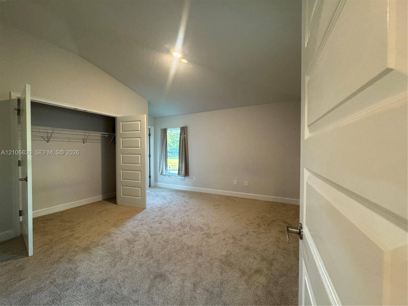 187 NW 45th Loop, Ocala, FL 34475 Vaulted ceilings, neutral carpeting, multi-panel interior doors, and a closet with wire shelving