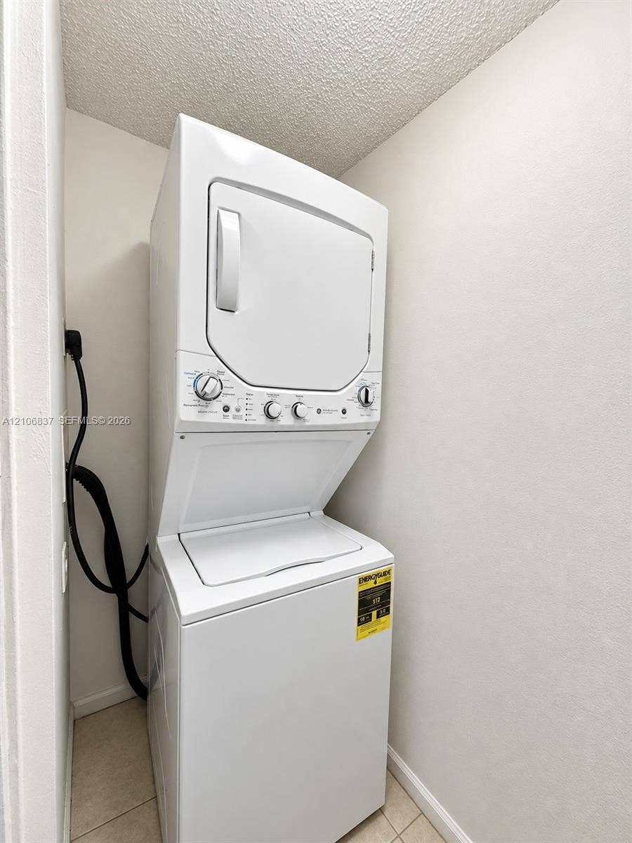 Stacked laundry unit with white finish and integrated control panel