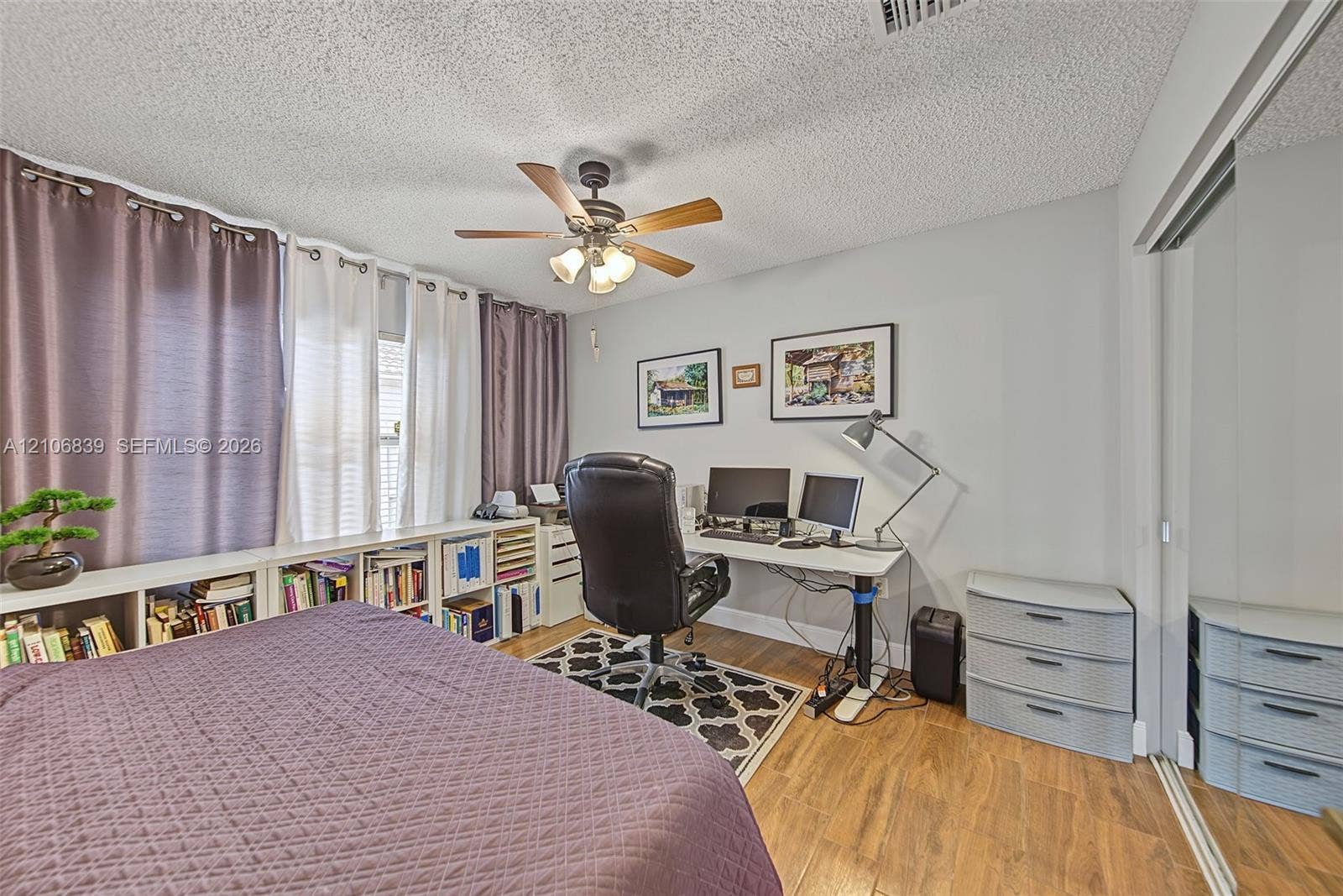 12683 NW 11th Place, Sunrise, FL 33323 Wood-finish flooring, ceiling fan with integrated lighting, and mirrored sliding closet doors