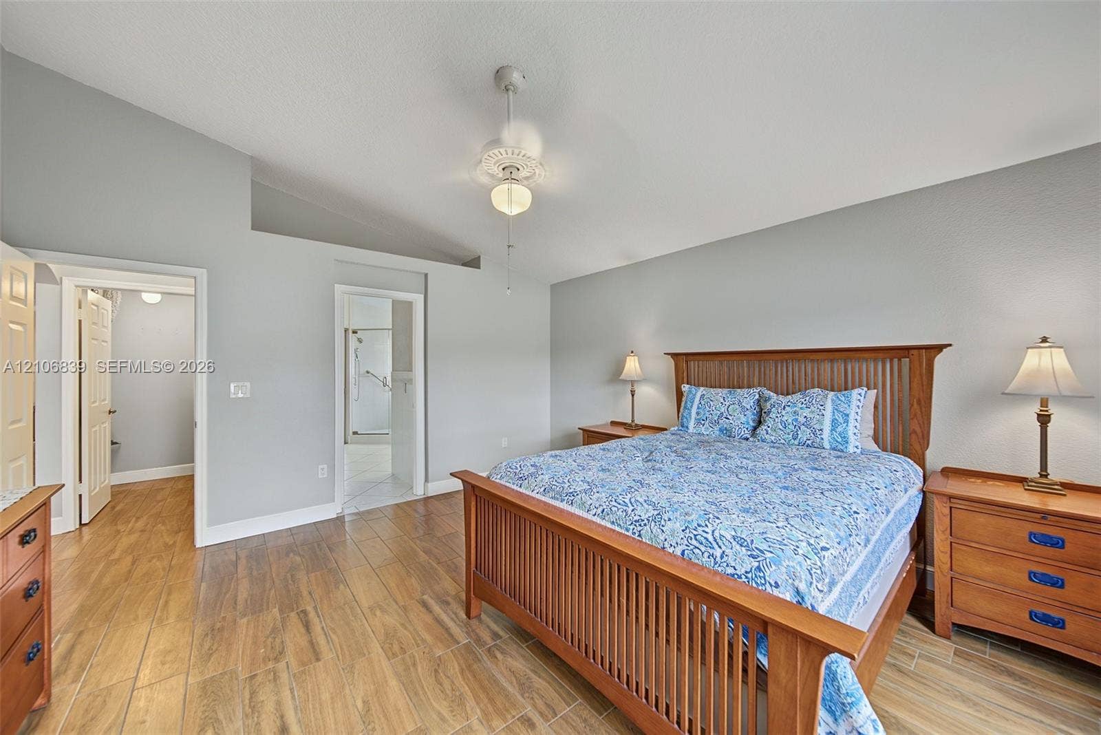 12683 NW 11th Place, Sunrise, FL 33323 Vaulted ceiling with a central fan, wood-finish flooring, and crisp neutral wall paint