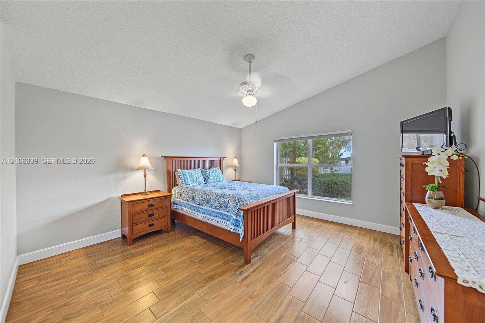 12683 NW 11th Place, Sunrise, FL 33323 Vaulted ceilings, wood-finish tile flooring, and a central ceiling fan
