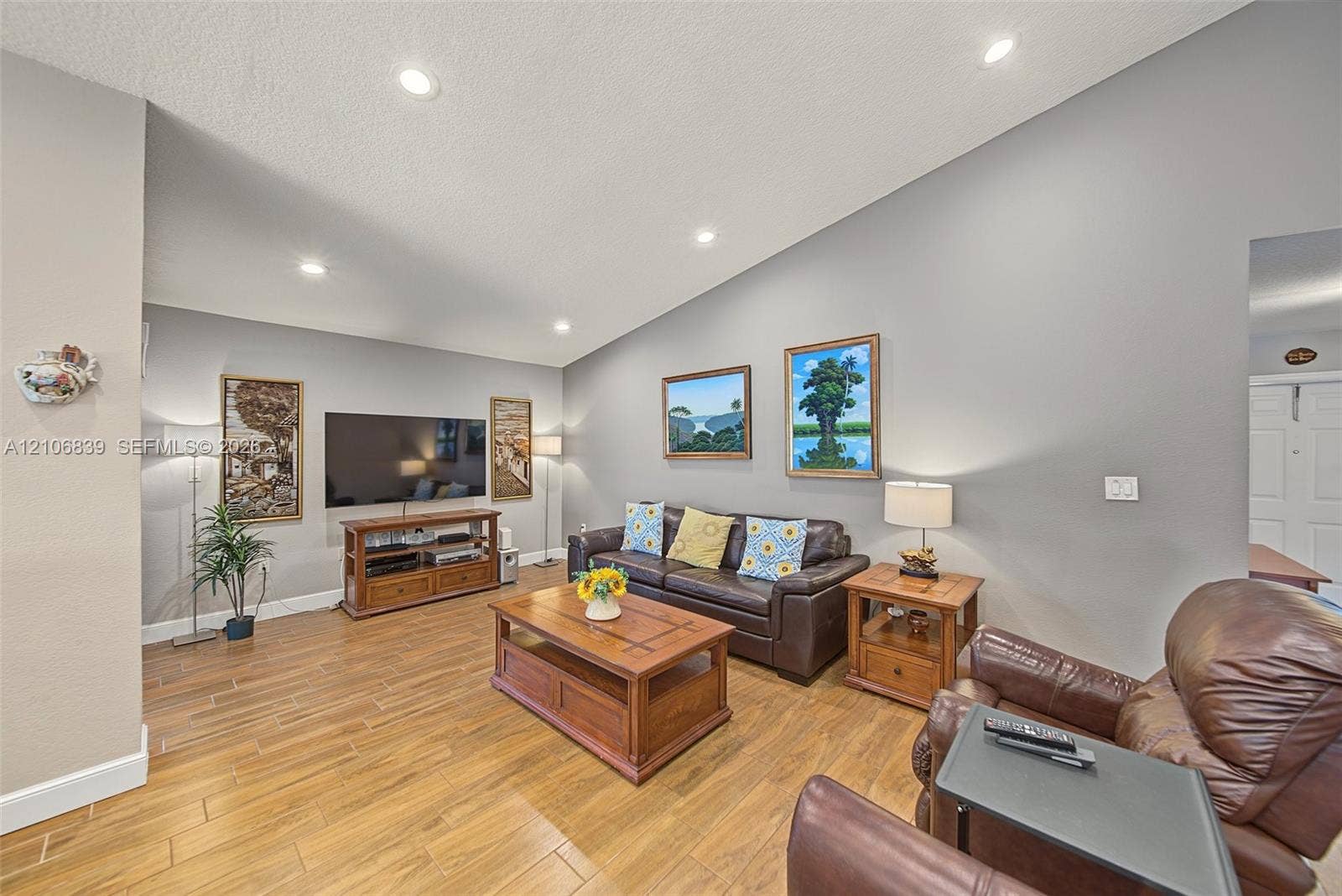 12683 NW 11th Place, Sunrise, FL 33323 Living area featuring high vaulted ceilings, recessed lighting, and wood-finish tile flooring