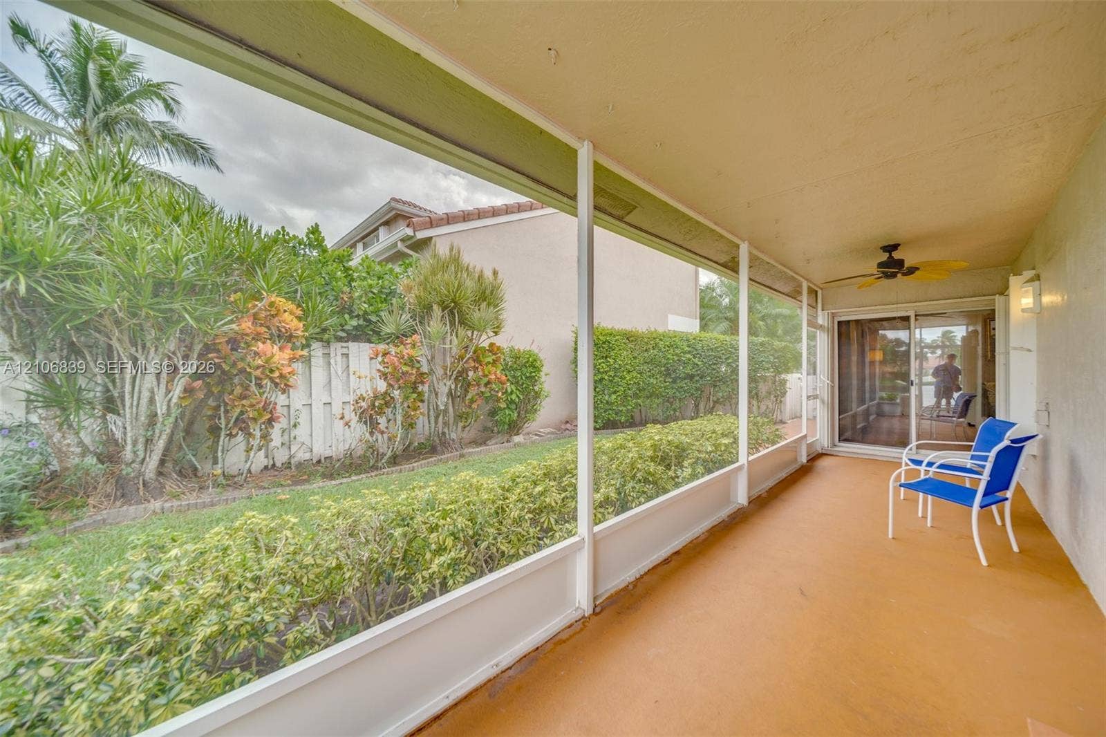 12683 NW 11th Place, Sunrise, FL 33323 Screen-enclosed lanai featuring a solid concrete floor, ceiling fan, and sliding glass door entry