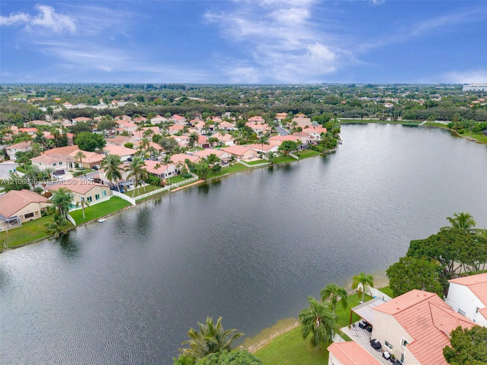 12683 NW 11th Place, Sunrise, FL 33323 Aerial perspective featuring waterfront property, expansive lake frontage, and tropical landscaping