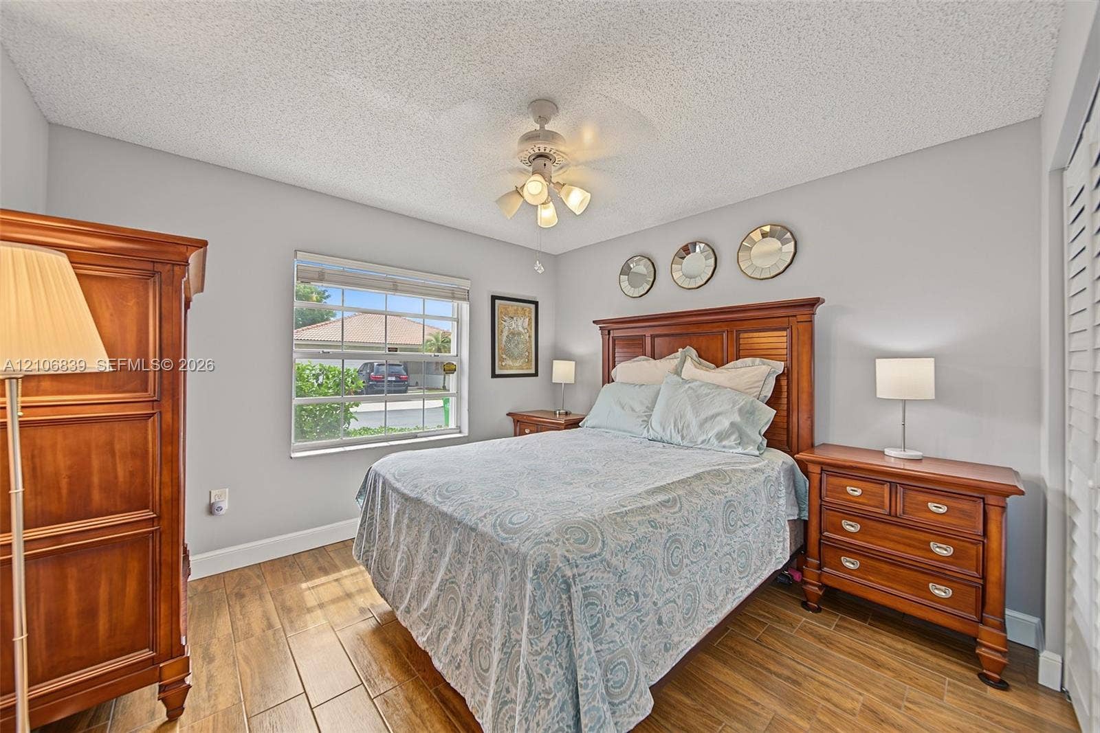12683 NW 11th Place, Sunrise, FL 33323 Wood-finish flooring, multi-light ceiling fan, and window with muntin detailing