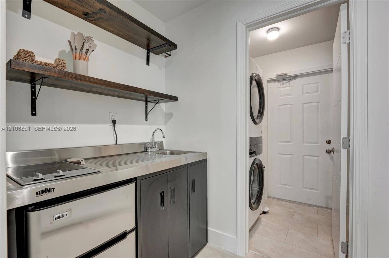 1319 SW 30th Street, #B, Fort Lauderdale, Fort Lauderdale, FL 33315 Utility space featuring a stainless steel countertop, integrated sink, built-in cooktop, under-counter refrigerator, and wood-finish wall shelving