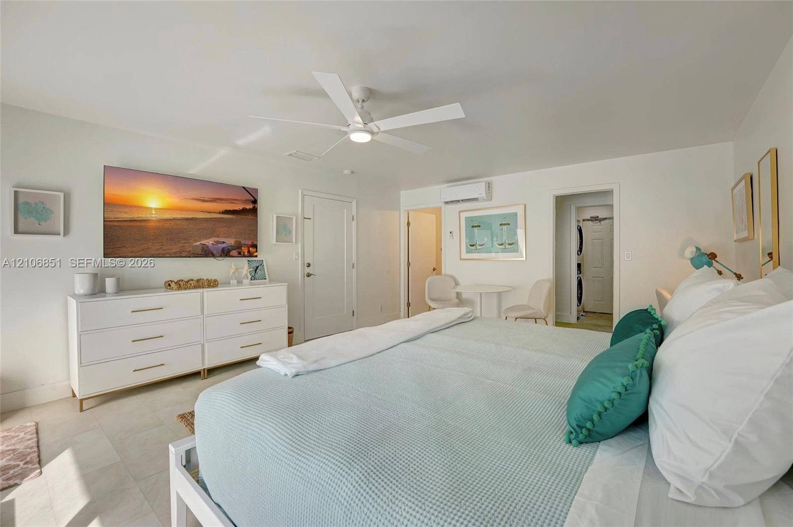 1319 SW 30th Street, #B, Fort Lauderdale, Fort Lauderdale, FL 33315 Neutral-toned interior featuring large-format tile flooring, a white five-blade ceiling fan, and a wall-mounted ductless heating and cooling unit