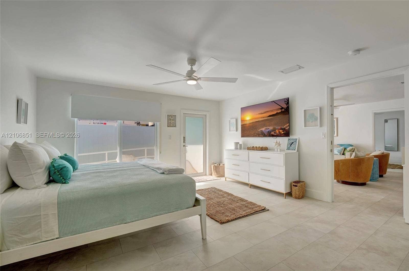 1319 SW 30th Street, #B, Fort Lauderdale, Fort Lauderdale, FL 33315 Neutral-toned tile flooring, white-finished ceiling fan with integrated lighting, and glass-paned exterior door