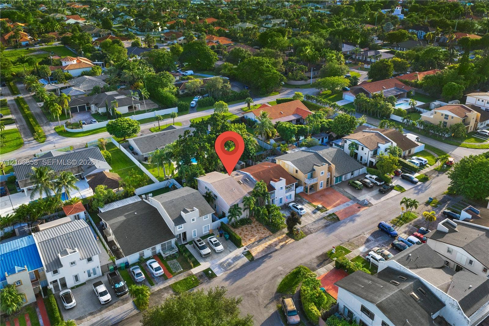 10960 SW 25th Street, Miami, FL 33165 Aerial view of property featuring a paved driveway, tile roofing, and landscaped perimeter
