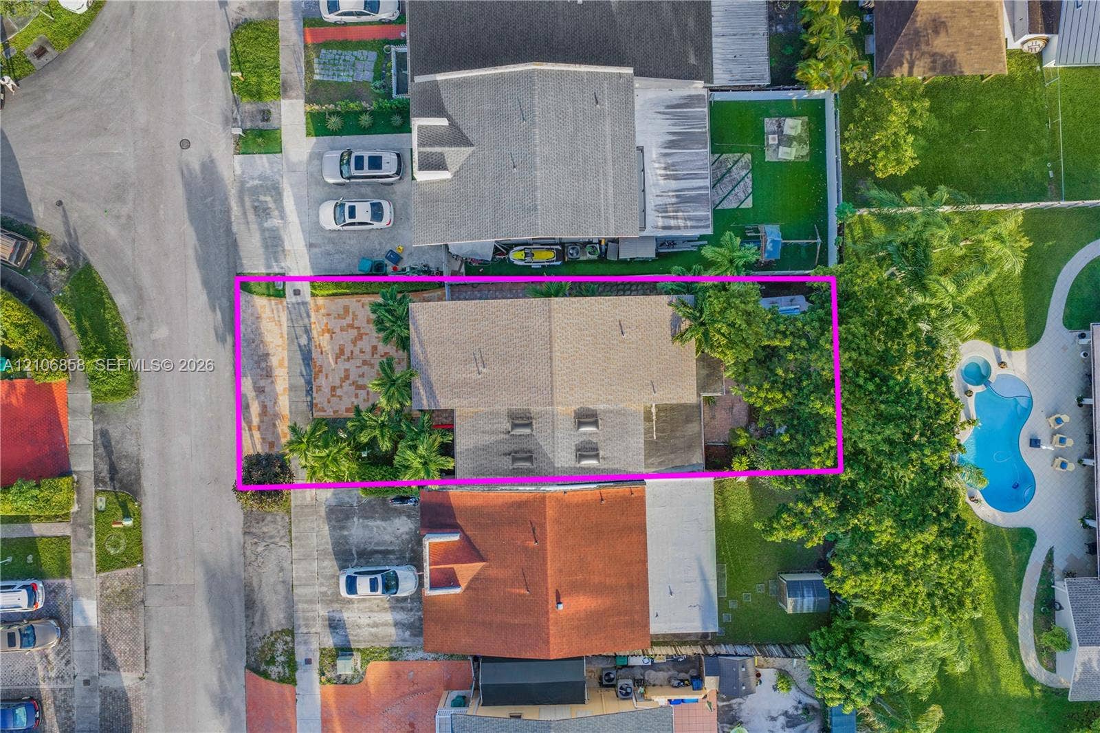 10960 SW 25th Street, Miami, FL 33165 Aerial perspective showcasing a parcel featuring a paved front courtyard, gable roofline, and mature landscaping
