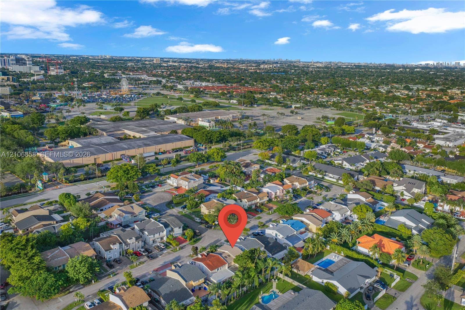 10960 SW 25th Street, Miami, FL 33165 Aerial perspective of residential suburban neighborhood featuring varied rooflines, paved street access, and established tree canopy