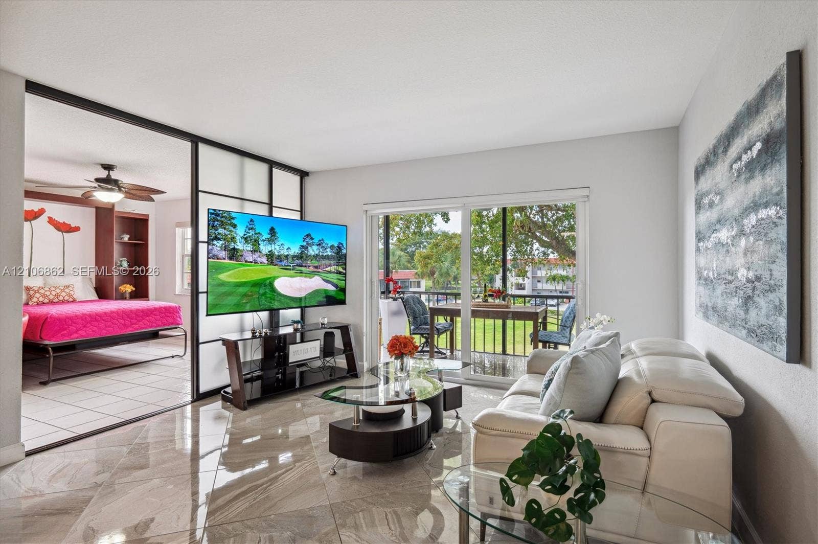Large-format tile flooring, sliding glass patio door, and sliding interior panel divider with frosted glass inserts