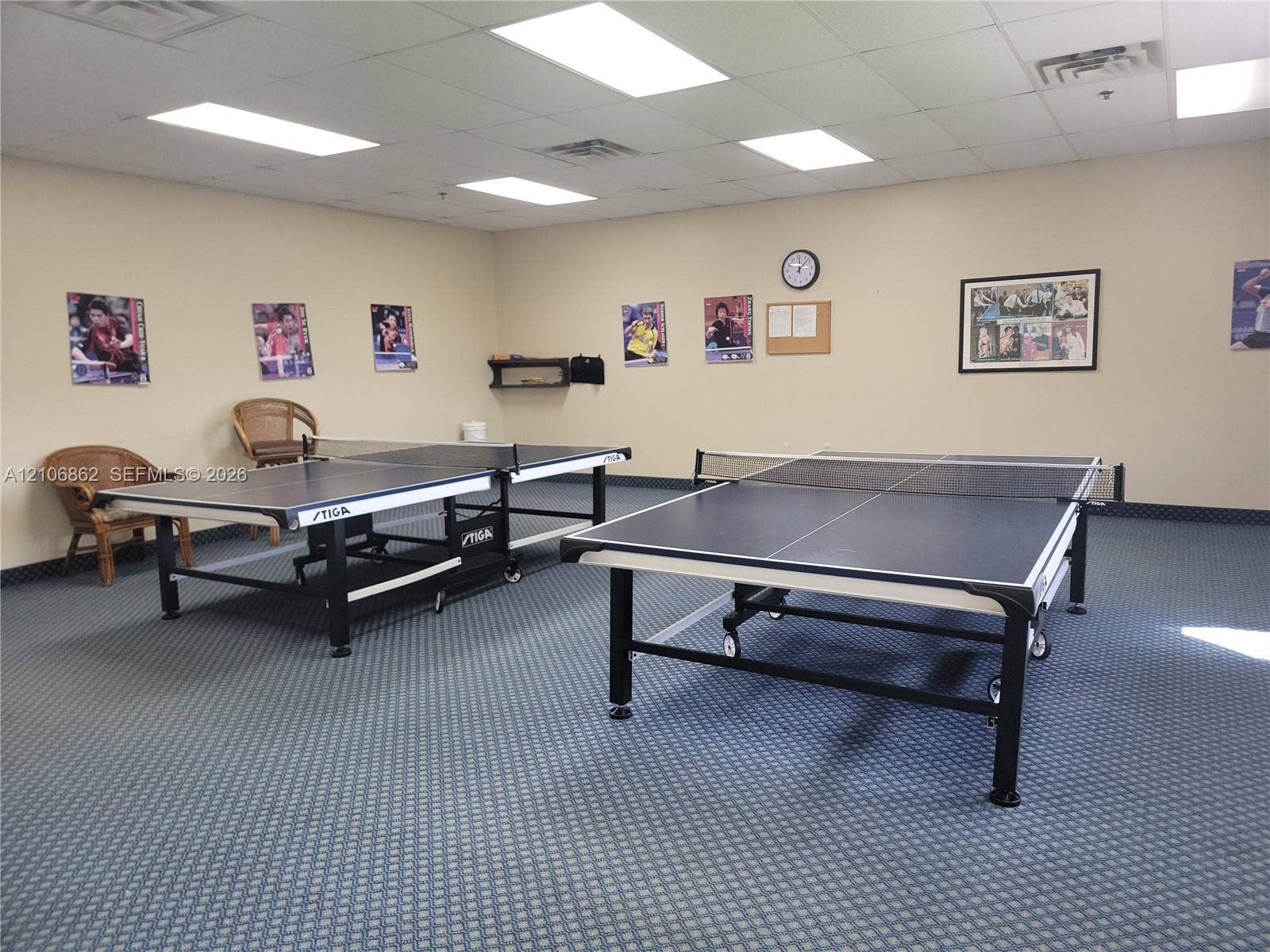 Spacious room featuring a drop ceiling with recessed lighting and wall-to-wall carpeting
