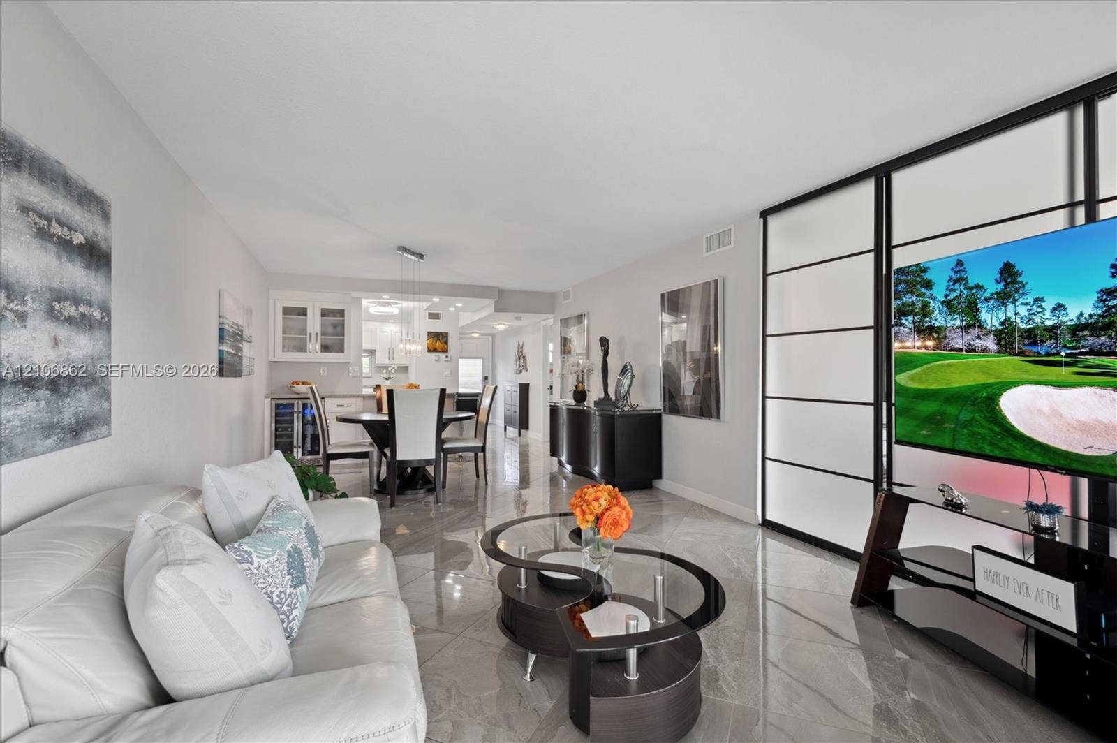 Large-format polished tile flooring, black-framed floor-to-ceiling frosted glass partition, and recessed ceiling lighting